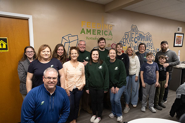 Group photo of Magnolia Bank team members volunteering at Feeding America