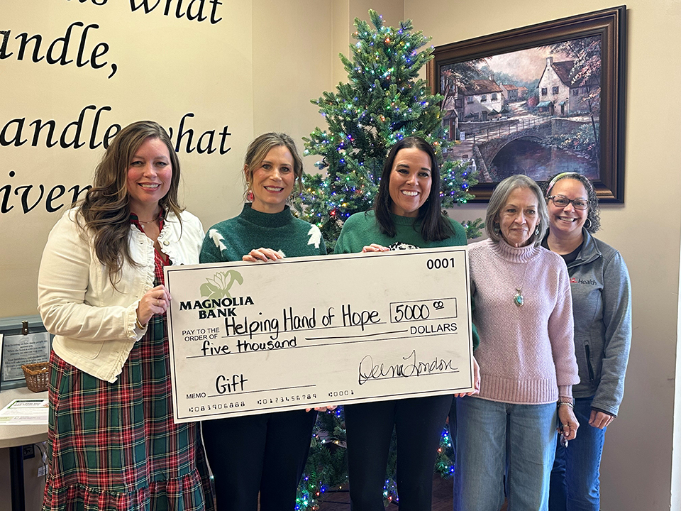 Group photo of Magnolia Bank team members presents a $5,000 check to Helping Hand of Hope